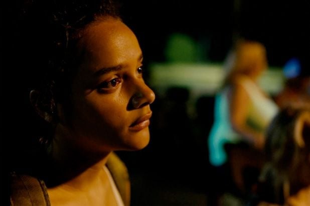 Star looking out – A close-up of Star (Sasha Lane), her face softly lit by golden light, gazing into the distance with quiet intensity.